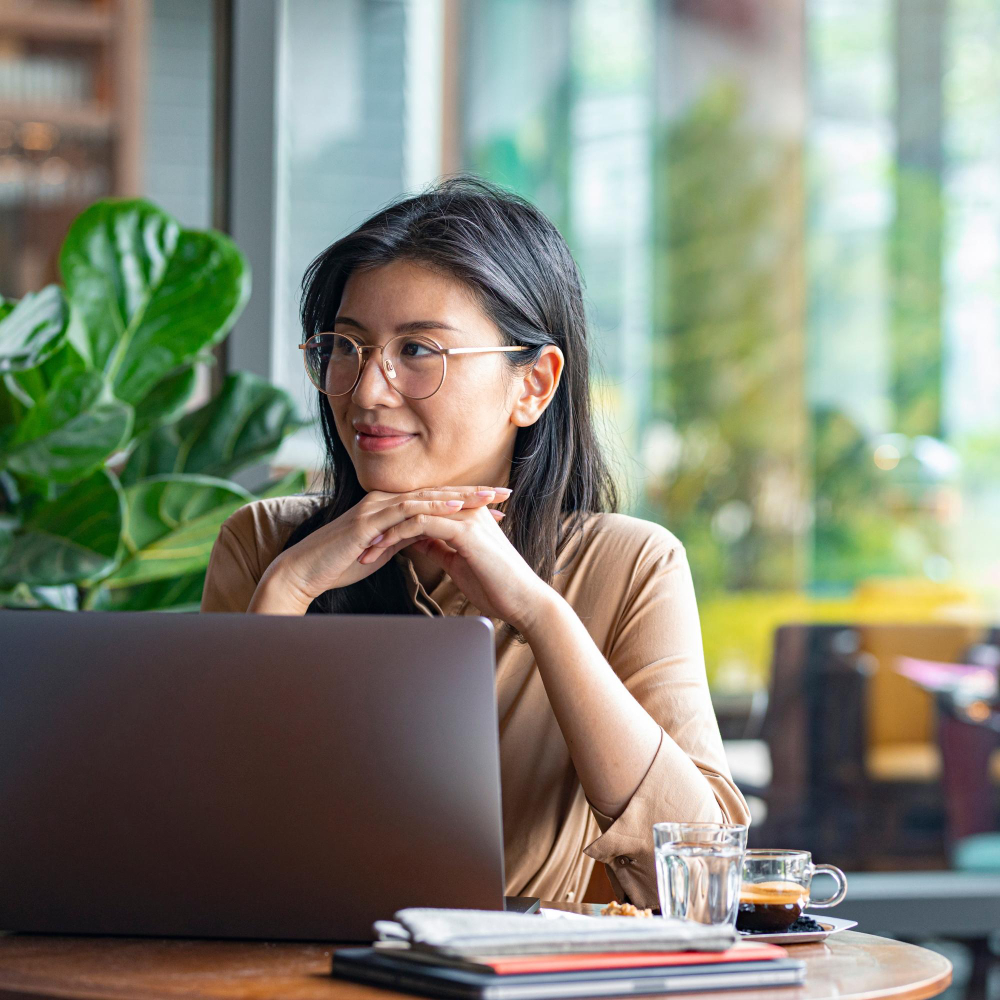 digital-nomads-smiling-asian-businesswoman-sitting-cafe-working-her-laptop-computer